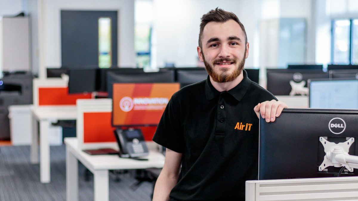 Air IT Support Worker sat at desk in office