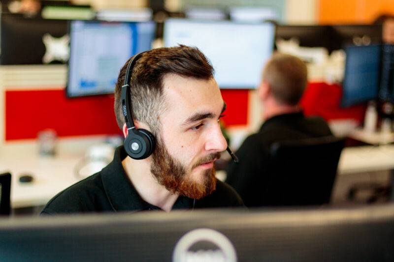 An Air IT employee working on a computer.