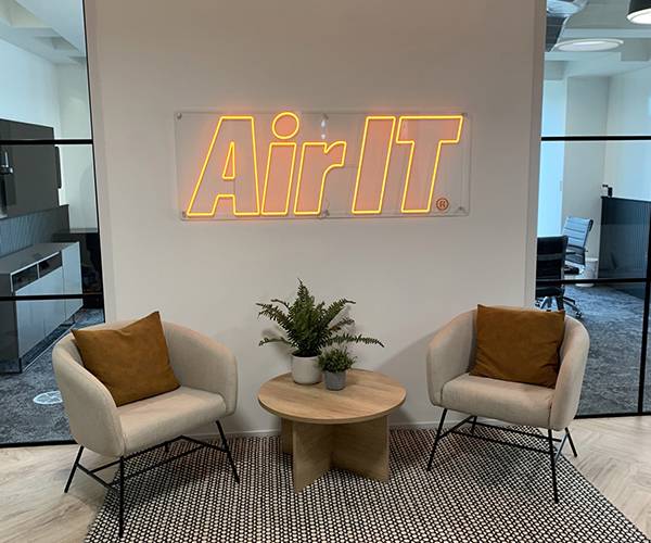 air it london inside the waiting area before going into the office. Showing the Air IT logo light and chairs